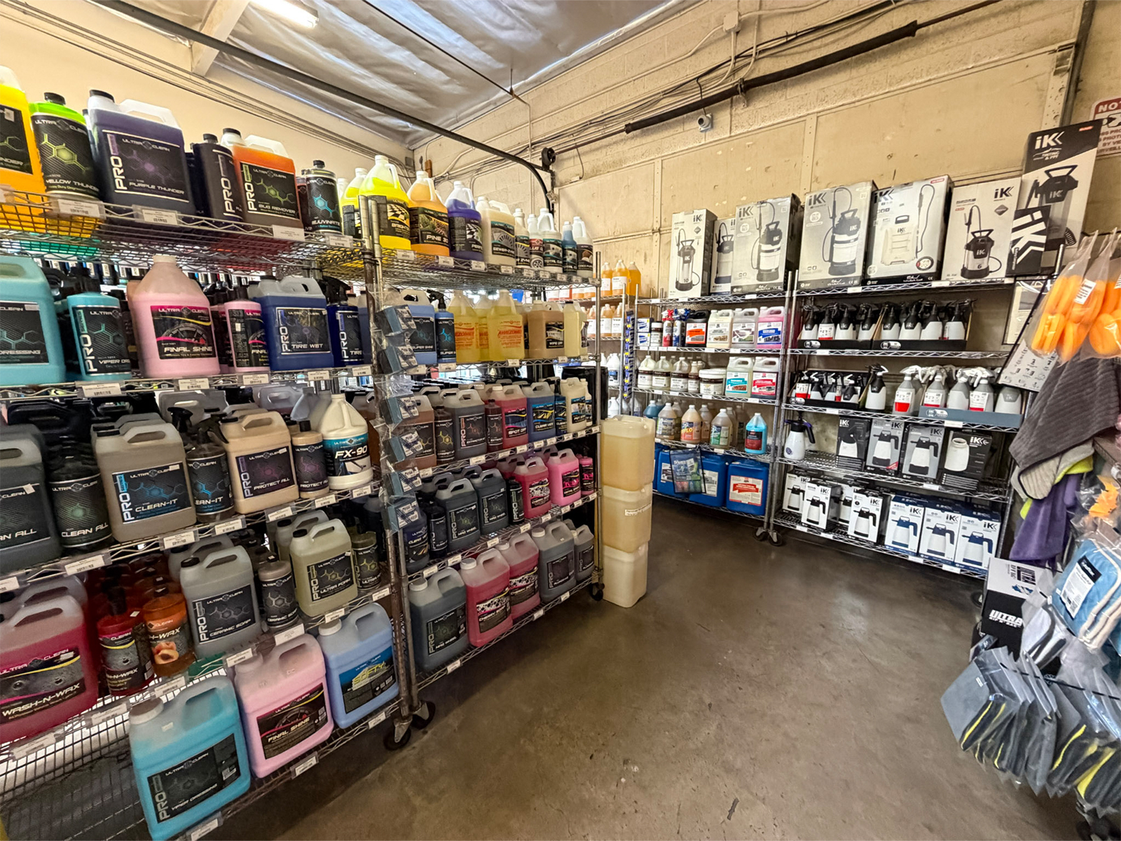 Detailing chemicals and accessories on shelves at PES Glendale